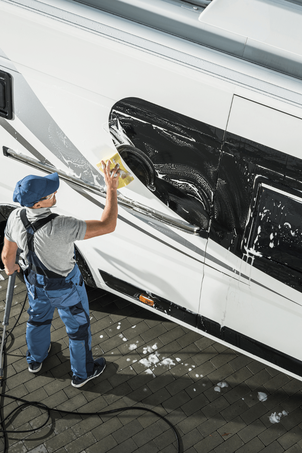 A man cleaning his motorhome in preparation for summer